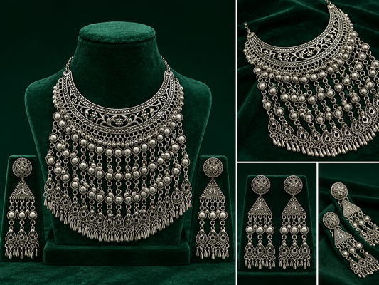 Silver-toned traditional jewelry set displayed on a dark green velvet background, including a statement necklace on a mannequin bust, matching drop earrings, and close-up inset views of the necklace and earrings.